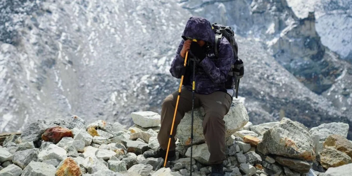 Trekker resting during high-altitude hike in the rocky mountains of Ladakh