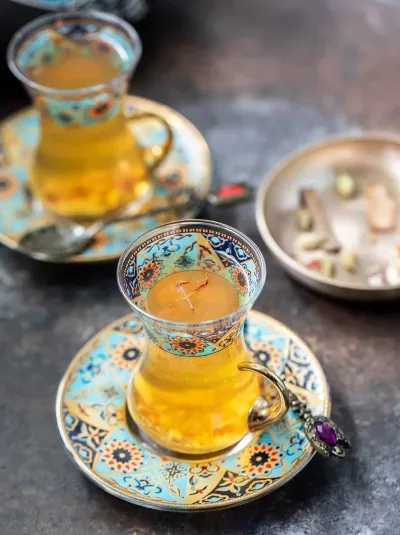 Kahwa Kashmiri green tea brewed with saffron, cardamom, cinnamon, and crushed almonds — warm, fragrant, lightly sweet, and traditionally served in a samovar.